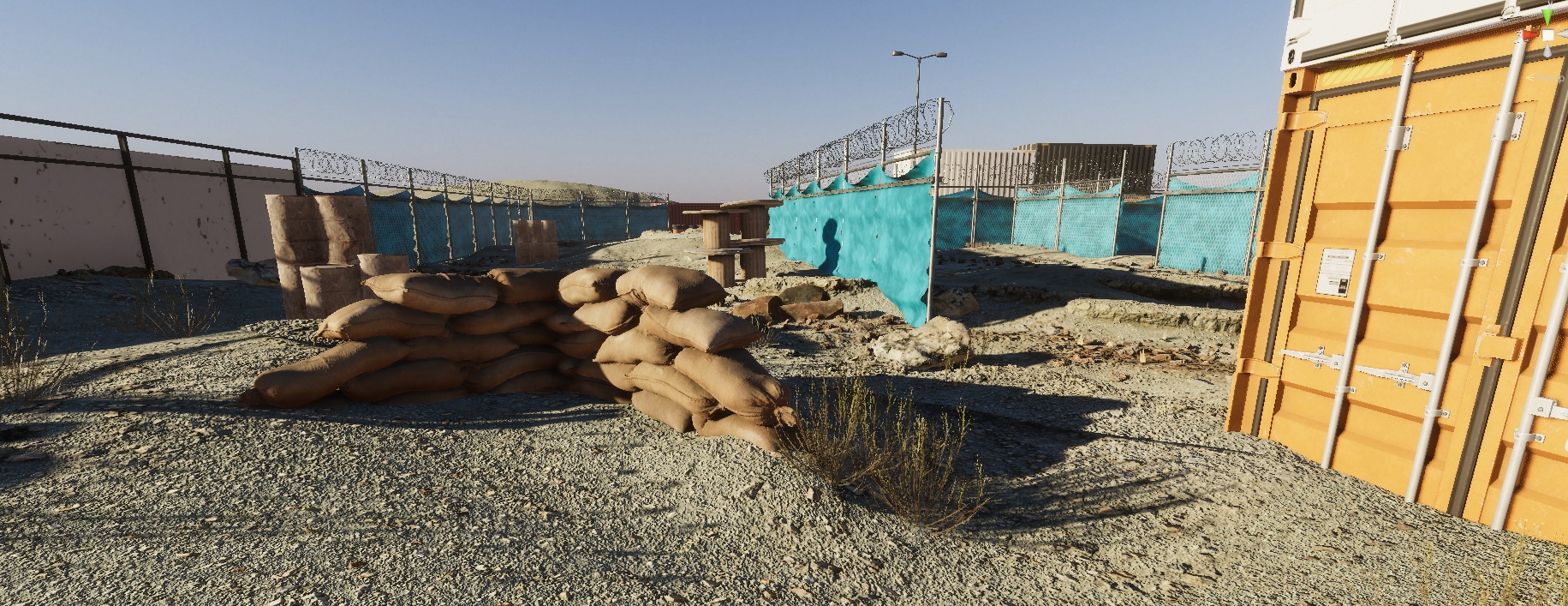 Wide final real-time environment view with sandbag cover, fencing, and a container landmark